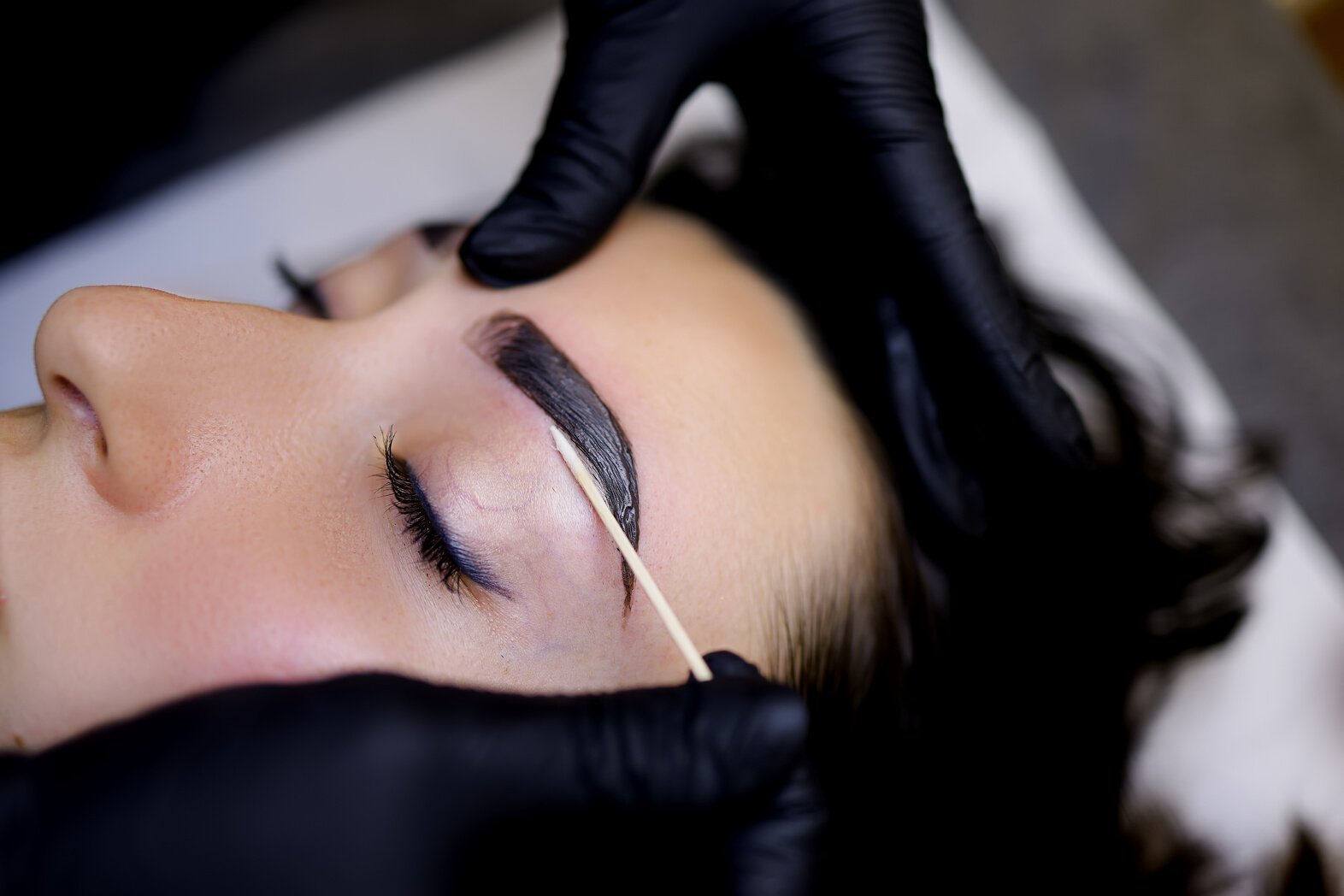 A Close-up of the Procedure of Coloring the Eyebrows with Paint